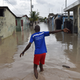 A man walks down a flooded street, in a neighbourhood of the commune of Cite Soleil, in the Haitian Capital Port-au-Prince, on October 4, 2016. Hurricane Matthew slammed into Haiti, triggering floods and forcing thousands to flee the path of a storm that has already claimed three lives in the poorest country in the Americas. (Image: Getty)